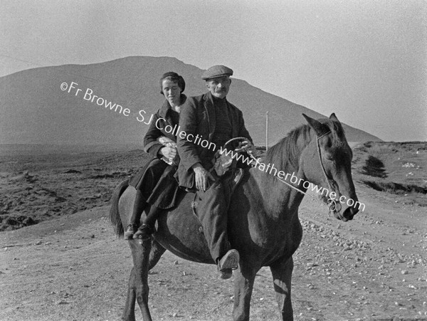 MAN & WOMAN ON HORSEBACK NEAR DUNKINEELY